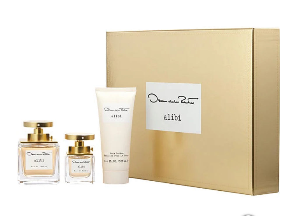 Oscar de la Renta 'alibi' perfume set with gold box, bottles, and cream