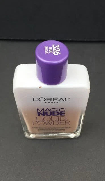 L'Oreal Paris Magic Nude Liquid Powder in Shade 326 True Beige. The 27ml glass bottle features a purple and silver cap, showing the liquid-to-powder foundation with a medium, neutral-toned beige shade perfect for natural skin perfecting