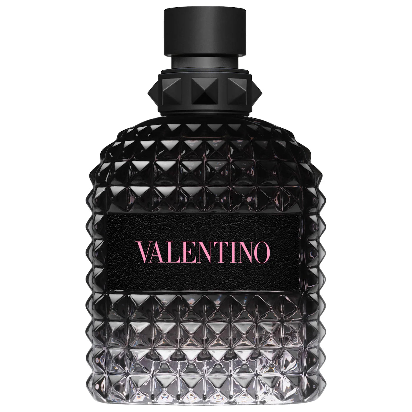 A single bottle of Valentino Born In Roma For Him Eau de Toilette. The signature black bottle features the iconic Valentino rockstud texture with a vibrant pink 'Roma' logo. The liquid inside is a cool, clear violet-grey