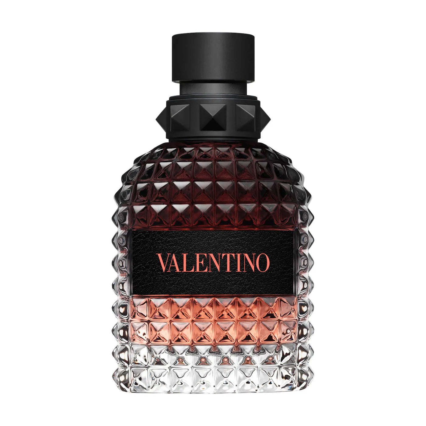 A single bottle of Valentino Born In Roma Coral Fantasy Eau de Toilette. The signature rockstud glass bottle reveals a vibrant coral-orange liquid, topped with a matte black rockstud cap and the iconic Valentino logo in black