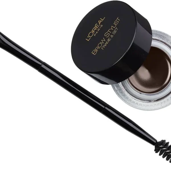 Product shot of the L'Oreal Frame and Set brow pomade in shade 214 Warm Brunette. The image shows the glass pot of warm brown cream and the included dual-ended application tool.
